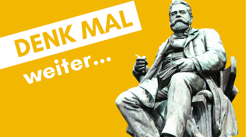 Statue eines sitzenden Mannes vor gelbem Hintergrund; daneben steht schräg der Text „DENK MAL weiter…“.